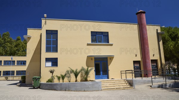 Gymnasium, Modern beige building with blue doors and windows under a clear sky, Historicism, Art Deco, Rationalism, Portolago, Lakki, Leros, Dodecanese, Greek Islands, Greece