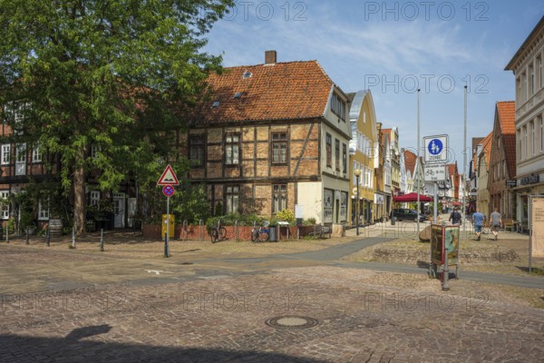Historic half-timbered houses with red bricks, quiet street neighbourhood with bicycles, Verden an der Aller, Lower Saxony, Germany