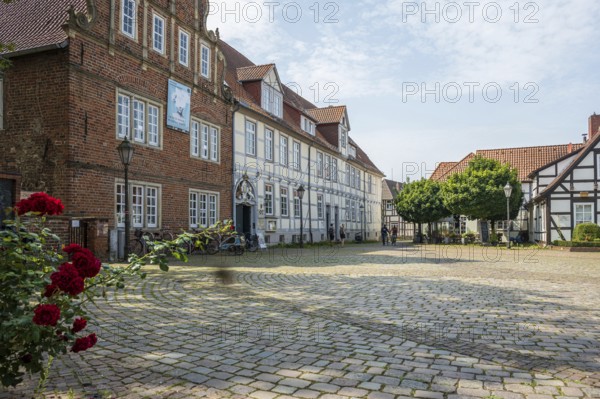 Historic half-timbered houses with cobbled square and roses. Quiet and peaceful atmosphere, Verden an der Aller, Lower Saxony, Germany