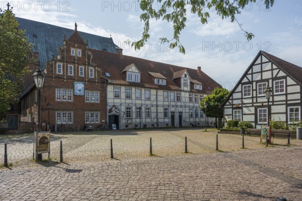 Historic half-timbered houses on a sunny day. Quiet neighbourhood, paved square, Verden an der Aller, Lower Saxony, Germany