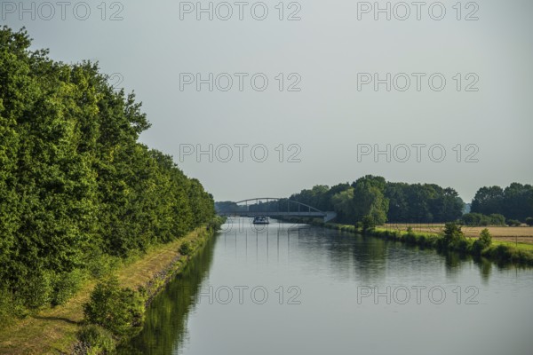 Canal with bridge and green banks, peaceful and quiet surroundings, Weser cycle path, district of Nienburg Weser, Balge, Lower Saxony, Germany