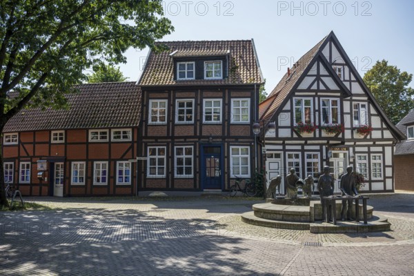 Row of traditional half-timbered houses along a quiet, cobbled street in summer, Weser cycle path, Nienburg Weser district, Nienburg Weser, Lower Saxony, Germany