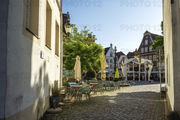 Idyllic alley with historic buildings and a cosy square in the sunshine, Warendorf, Münsterland, North Rhine-Westphalia