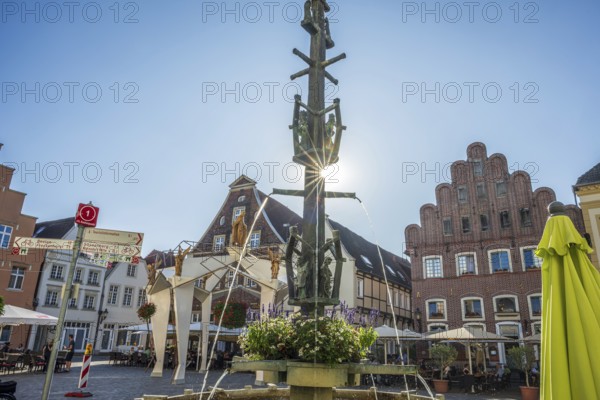 A fountain with fountains in a central square surrounded by half-timbered houses, Warendorf, Münsterland, North Rhine-Westphalia