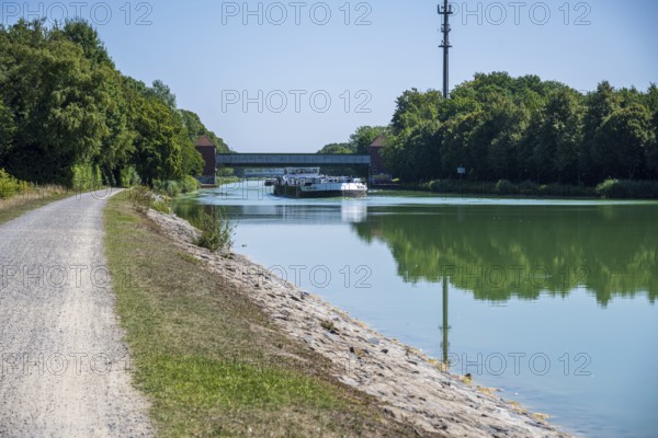 Canal with riverside path and bridge. Natural scenery with a summer atmosphere, Dortmund-Ems Canal near Lüdinghausen, Münsterland, North Rhine-Westphalia