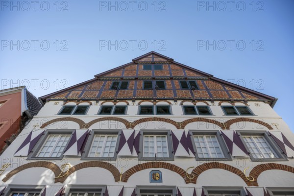 Half-timbered house with striking gables and windows, against a blue sky, Warendorf, Münsterland, North Rhine-Westphalia