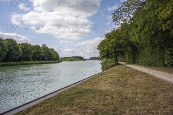 Idyllic river with adjoining path, framed by trees under a partly cloudy sky, Senden, Münsterland, North Rhine-Westphalia, Germany