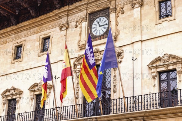 Spanish and Mallorcan flags with the EU flag on the balcony at city hall in Palma, Palma de Mallorca, Mallorca, Spain