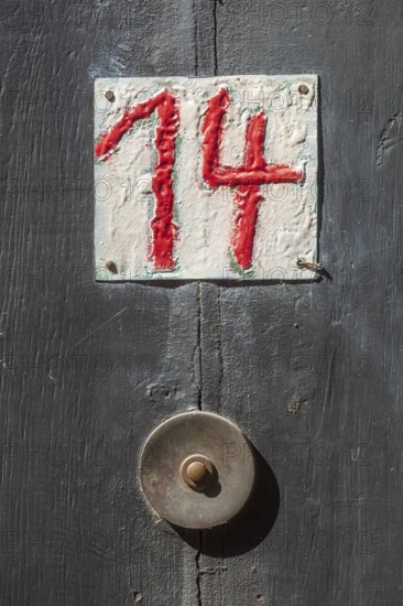 House number sign number fourteen and old doorbell on a half-timbered house in the old town centre, Hameln, Lower Saxony, Germany