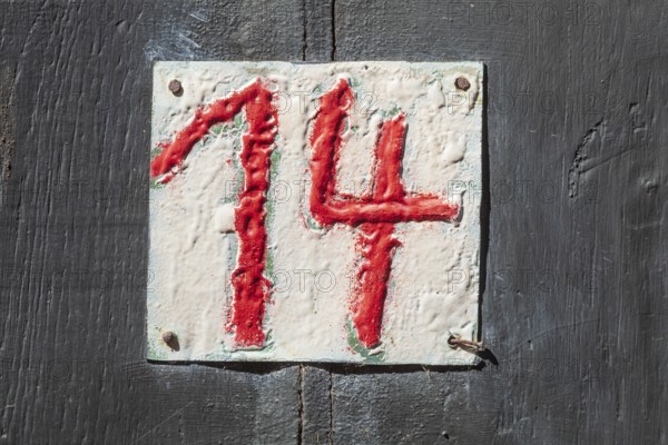 House number sign number fourteen on a half-timbered house in the old town centre, Hameln, Lower Saxony, Germany