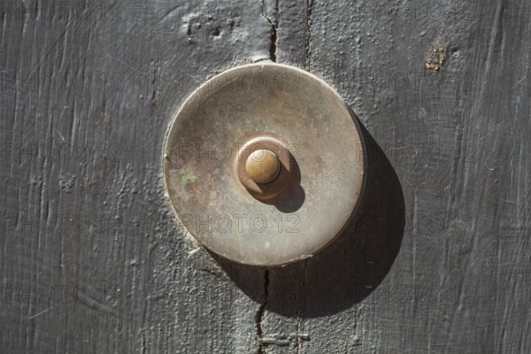 Old bell on a half-timbered house in the old town centre, Hamelin, Lower Saxony, Germany