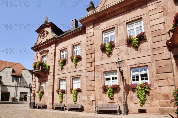 Ettlingen, Germany - August 13th 2025: Part of Ettlingen city hall (Rathaus) in Germany. Historic sandstone building with baroque architecture and flowers