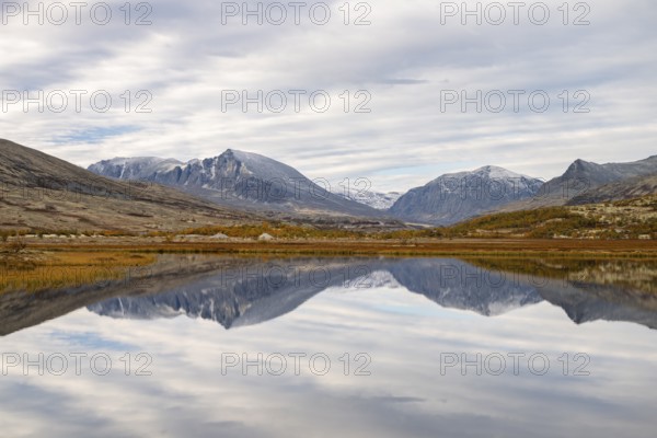 Reflection of the autumn landscape in Rondane National Park, Berge, Døråldalen, Norway