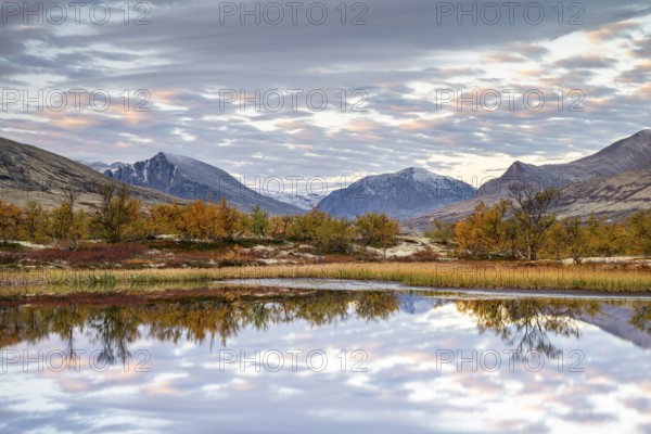 Reflection of the autumn landscape in Rondane National Park, Berge, Døråldalen, Norway