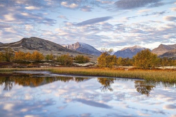 Reflection of the autumn landscape in Rondane National Park, Berge, Døråldalen, Norway