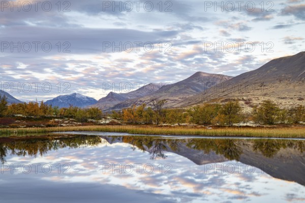 Reflection of the autumn landscape in Rondane National Park, Berge, Døråldalen, Norway