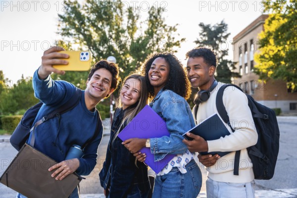Group of smiling multi ethnic students standing outdoors on campus, celebrating friendship, youth, and education while taking a cheerful selfie together in bright sunlight