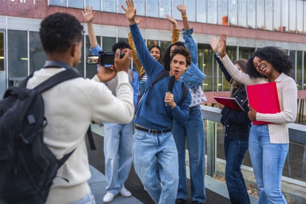 Young diverse students creating social media content together, vlogging on university campus while capturing cheerful moments and expressing happiness