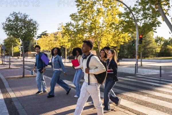 Multi ethnic group of university students walking across a campus crosswalk, smiling and chatting as they carry backpacks and books, symbolizing friendship, learning and youthful energy