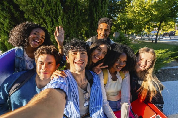 Group of happy multicultural young adult friends smiling and posing for a selfie while standing outdoors on a vibrant university campus, celebrating unity and friendship