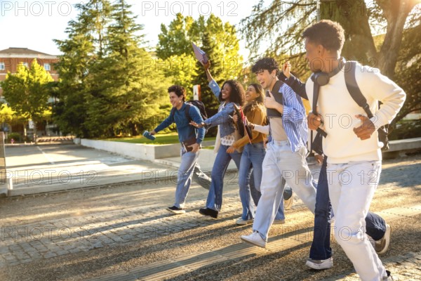 Group of diverse university students with backpacks running across campus at golden hour, laughing and celebrating friendship, energy, youth and future success