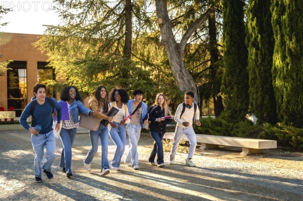 Diverse group of happy university students walking and talking together on campus, carrying books and backpacks, representing education and friendship