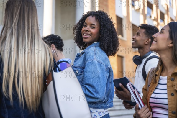 Group of multi ethnic university students walking together on campus, smiling, and looking around, representing youth, education, and friendship in an academic environment