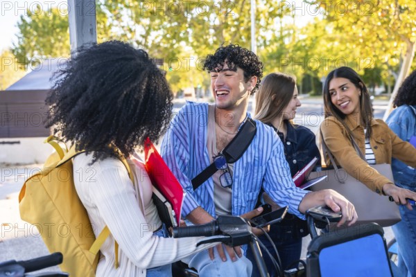 Young diverse students laughing and chatting with bikes and books on a sunny university campus, sharing friendship and energy while strolling and studying outdoors