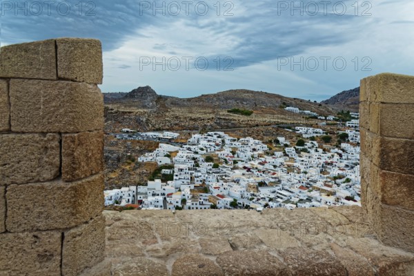 View from the Acropolis of Lindos to the city with white houses and cloudy sky, Acropolis, Lindos, Rhodes, Island, Greece