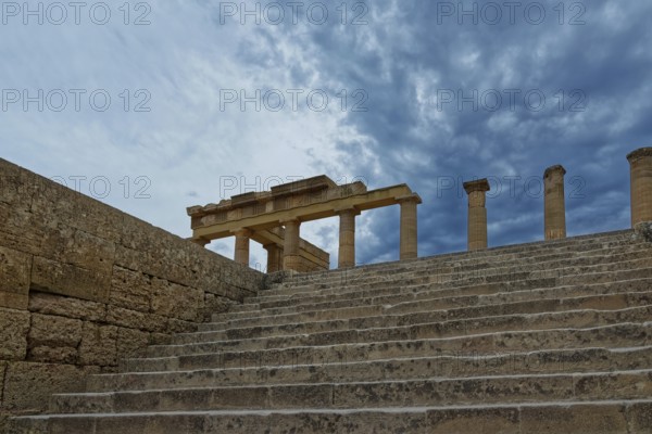 Ancient ruins with stone steps and columns of the Acropolis of Lindos under a dramatic sky, Acropolis, Lindos, Rhodes, Island, Greece