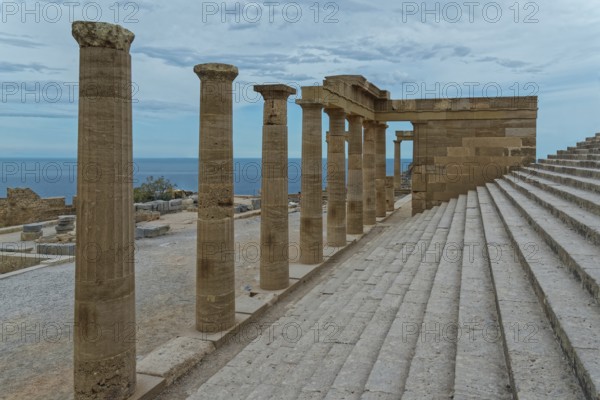 Ancient columns of the Acropolis of Lindos with a view of the sea and a staircase under a cloudy sky, Acropolis, Lindos, Rhodes, Island, Greece