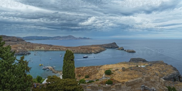 View of the coastal landscape of Lindos with the harbour full of boats, Acropolis, Lindos, Rhodes, Island, Greece