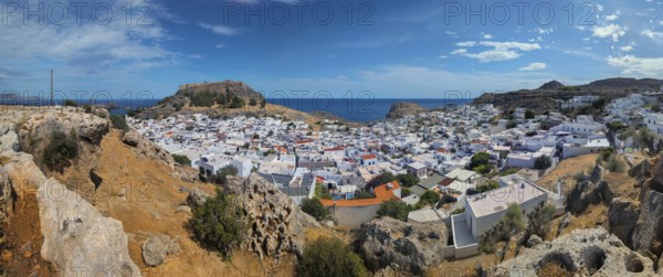 Panorama of the town of Lindos with Acropolis with white buildings by the sea under a blue sky, Acropolis, Lindos, Rhodes, island, Greece