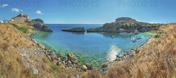 Clear panoramic view of Paulus Bay of Lindos with turquoise water and boats, Acropolis, Lindos, Rhodes, Island, Greece