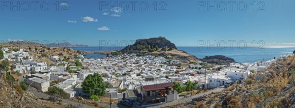 Panoramic view of the town of Lindos with Acropolis on the coast with a blue sky, Acropolis, Lindos, Rhodes, Island, Greece