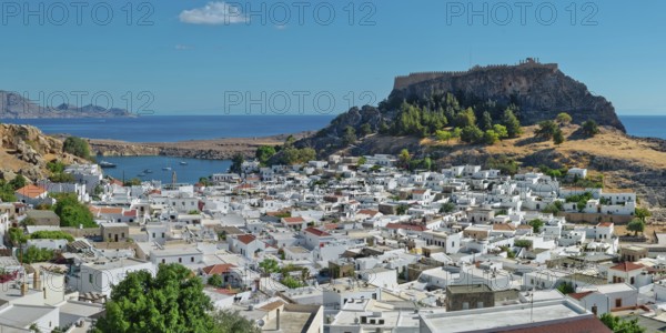 The picturesque town of Lindos with acropolis with white buildings near the coast, overlooked from the hill, Acropolis, Lindos, Rhodes, Island, Greece