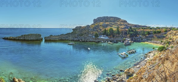 Panoramic view of the calm Paulus Bay of Lindos with turquoise-coloured water, surrounded by cliffs, Acropolis, Lindos, Rhodes, Island, Greece