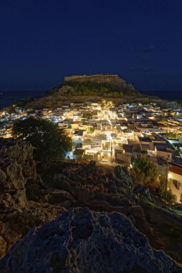 Night picture of the brightly lit town of Lindos and the ancient Acropolis on a rock in the background, Acropolis, Lindos, Rhodes, Island, Greece