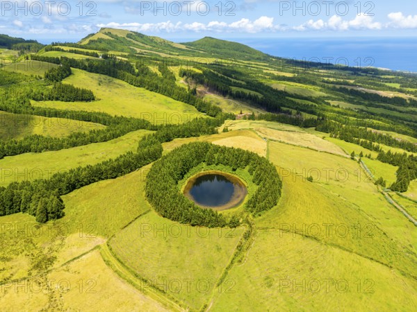 Lake Pau Pique and Lush Green Hills with Pastureland and Trees. Atlantic Ocean. Azores, Sao Miguel Island. Portugal. Aerial View