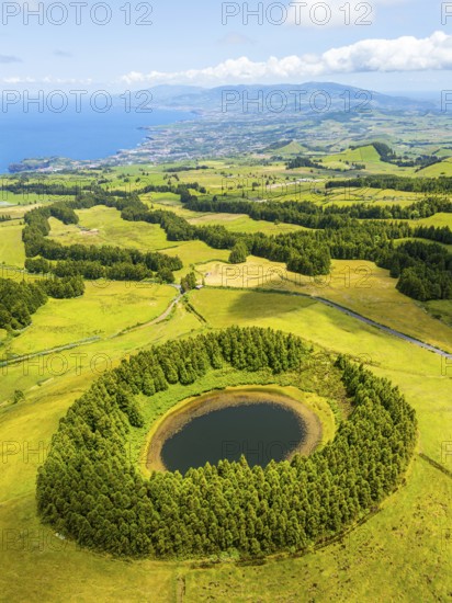 Pond Pau Pique and Lush Green Hills with Pasturelands. Atlantic Ocean. Azores, Sao Miguel Island. Portugal. Aerial Drone Shot