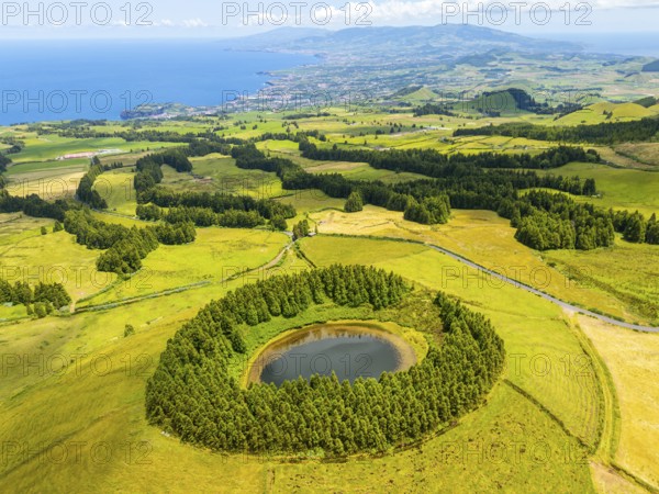 Lake Pau Pique and Lush Green Hills with Pasturelands on Sunny Day. Atlantic Ocean. Azores, Sao Miguel Island. Portugal. Aerial View