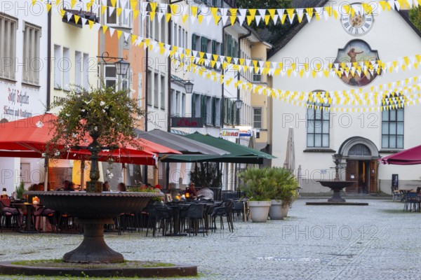 Fountain, outdoor seating at a restaurant, parasols, St John's Church, market square, Feldkirch, Vorarlberg, Austria
