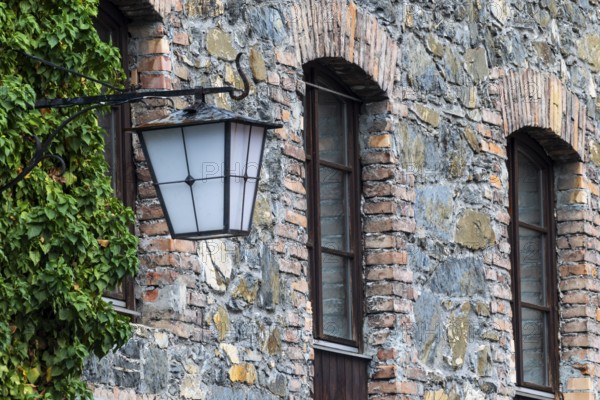 Old stone façade, historic lantern, Mühletorplatz, Feldkirch, Vorarlberg, Austria