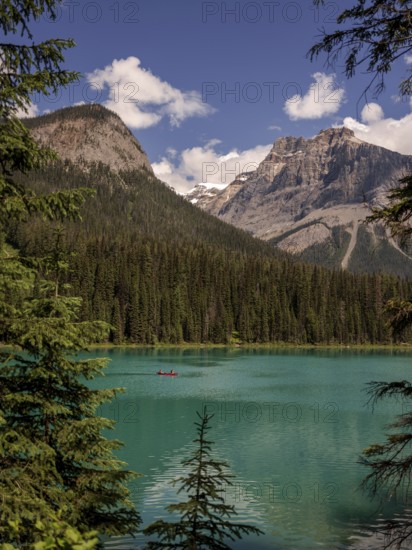 Kayak on Emerald Lake encircled by the Canadian Rocky Mountains and forest within Yoho National Park in Alberta, Canada, North Canada