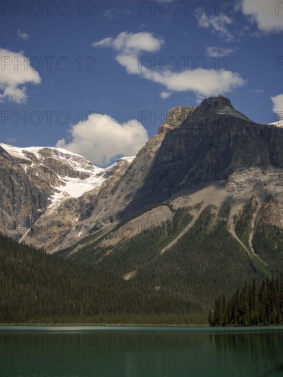 Towers of snowy peaks of the Canadian Rocky Mountains next to Emerald Lake inside Yoho National Park, British Columbia, Canada, North America
