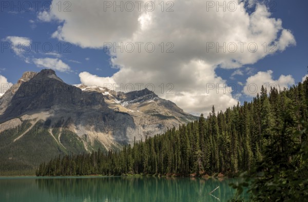 The Canadian Rocky Mountains with clouds above Emerald and dense forest inside Yoho National Park, British Columbia, Canada, North America