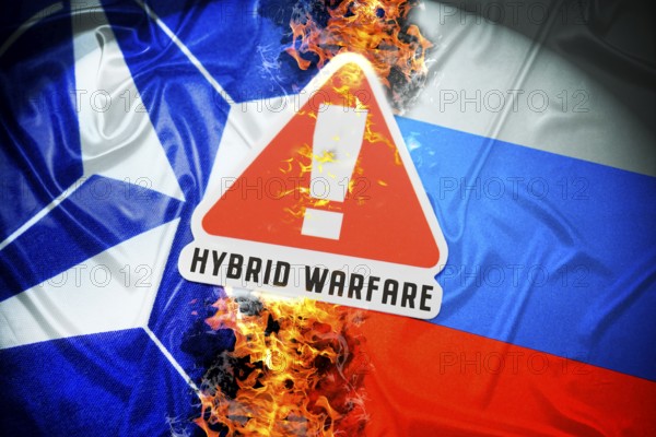The flags of NATO and Russia with danger sign and inscription Hybrid Warfare, symbolic photo of hybrid warfare, photomontage