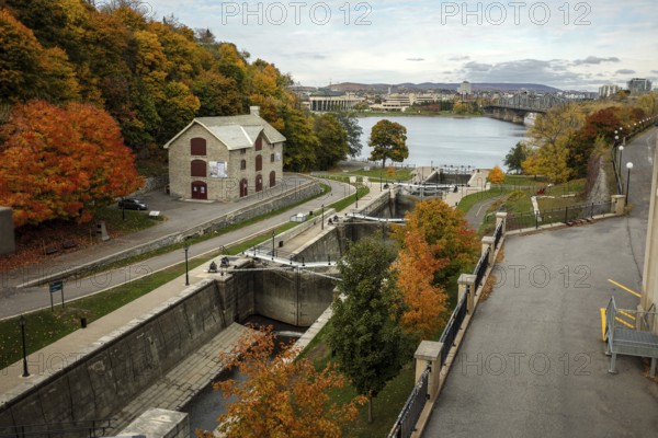 Elevated view of the Rideau canal and locks leading to the Ottawa River, lined by an autumn path with vibrant foliage in Ottawa, Ontario, Canada, North America