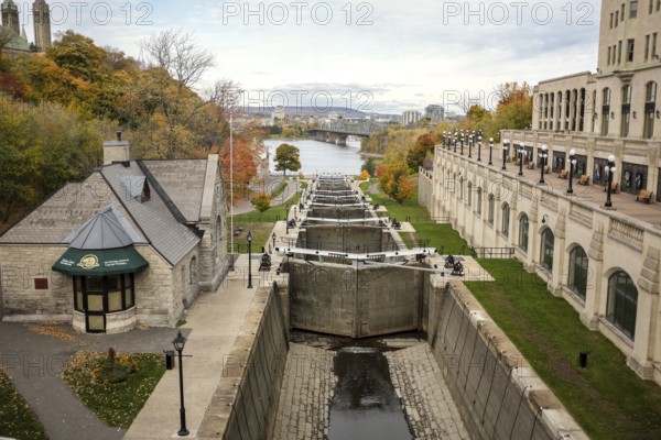 Scenic view of the Rideau Canal locks, leading to the Ottawa River surrounded by autumn trees and historic buildings in Ottawa, Ontario, Canada, North America