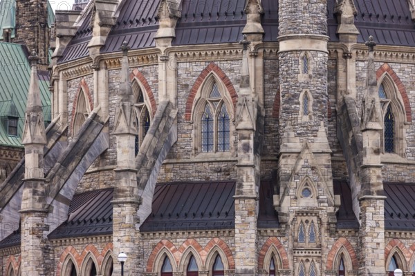 A close-up of the Canadian Parliament Buildings with stone facade with gothic architectural details and spires in Ottawa, Ontario, Canada, North America